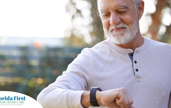 A senior man wears a smart watch, representing one of the many ways smart technology is shaping home health care.