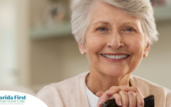 An older woman with healthy teeth smiles, representing good dental hygiene.